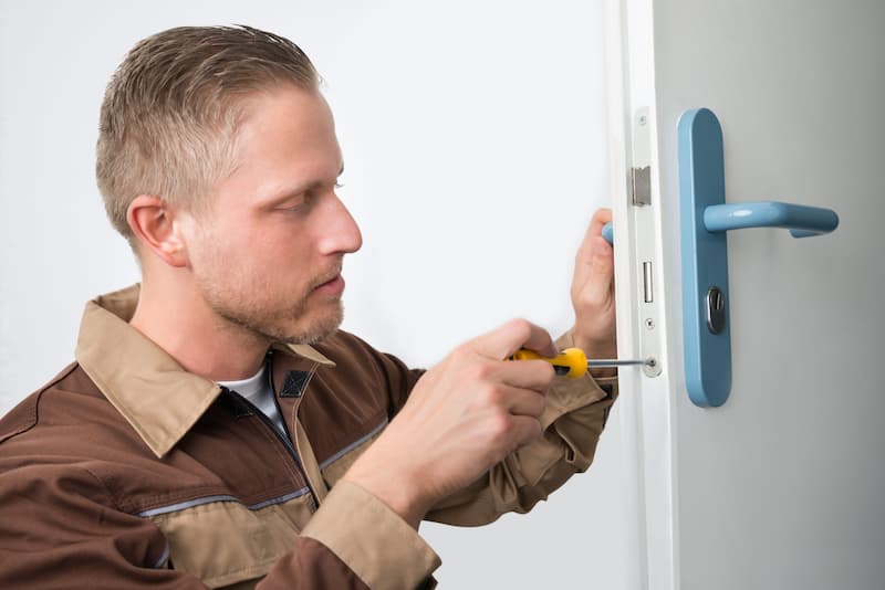 Compressed_72462772 carpenter-repairing-door-lock-scaled.jpg